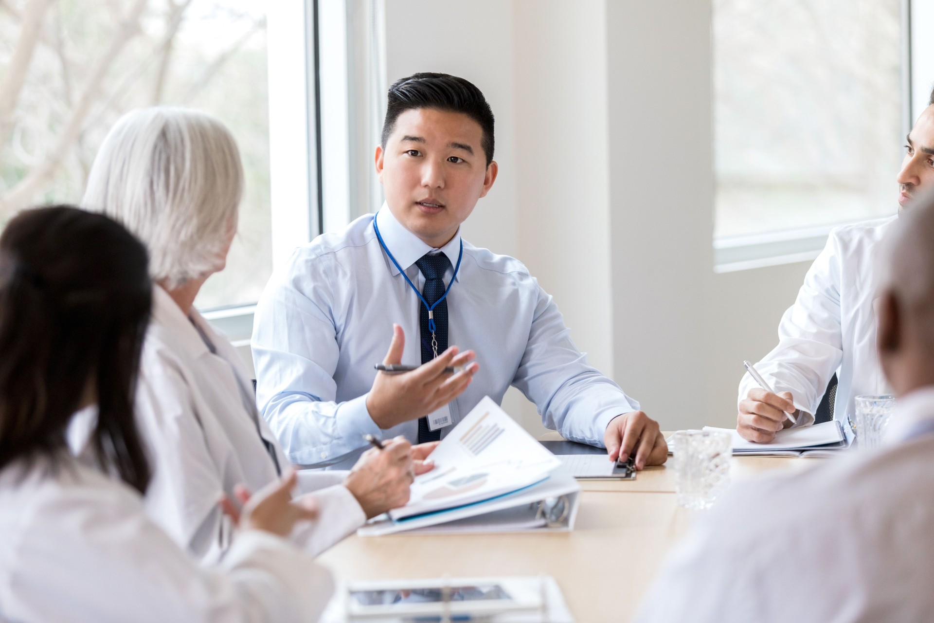 Serious hospital executive talks during meeting